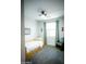 Well-lit bedroom with neutral decor, and comfortable seating near a window at 7531 E Billings St # 132, Mesa, AZ 85207
