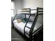 Functional bedroom features a sturdy bunk bed, maximizing space with neutral decor, ideal for or guests at 7531 E Billings St # 132, Mesa, AZ 85207