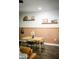 Cozy dining area featuring a wooden table and chairs, complemented by decorative shelving and neutral accents at 7531 E Billings St # 132, Mesa, AZ 85207