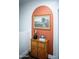 Stylish hallway featuring a rustic cabinet, decorative accessories, and artistic wall decor at 7531 E Billings St # 132, Mesa, AZ 85207