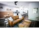 Open-concept living room with a leather couch, modern decor, and seamless flow into the kitchen at 7531 E Billings St # 132, Mesa, AZ 85207