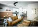 Open-concept living room with a leather couch, modern decor, and seamless flow into the kitchen at 7531 E Billings St # 132, Mesa, AZ 85207