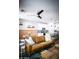Open-concept living room with a leather couch, modern decor, and seamless flow into the kitchen at 7531 E Billings St # 132, Mesa, AZ 85207