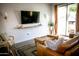 Cozy living room featuring a modern TV, stylish furniture, and a large sliding glass door at 7531 E Billings St # 132, Mesa, AZ 85207