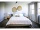 Sunlit main bedroom featuring a cozy bed, neutral tones, and well-placed windows, enhancing comfort and style at 7531 E Billings St # 132, Mesa, AZ 85207