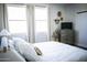 Serene main bedroom with a plush bed, soft lighting, and chic decor, designed for optimal relaxation and comfort at 7531 E Billings St # 132, Mesa, AZ 85207