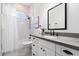 Bright bathroom featuring a vanity with a gray countertop, subway tile shower, and mosaic tile flooring at 804 E Palmaire Ave, Phoenix, AZ 85020