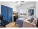 Cozy bedroom featuring a comfortable bed, blue closet doors, and a modern media setup at 804 E Palmaire Ave, Phoenix, AZ 85020
