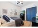 Bedroom featuring a comfortable bed, modern dresser, and blue sliding closet doors with window shutters at 804 E Palmaire Ave, Phoenix, AZ 85020