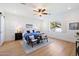 Bright bedroom with a ceiling fan, a large window, and a comfortable bed with blue accents at 804 E Palmaire Ave, Phoenix, AZ 85020