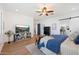 Bedroom featuring a TV, ceiling fan, and a sliding barn door that leads to the bathroom at 804 E Palmaire Ave, Phoenix, AZ 85020