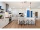 Bright, open kitchen featuring a large island with seating, stainless appliances, and white cabinetry at 804 E Palmaire Ave, Phoenix, AZ 85020