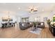 Spacious living room with a large sectional sofa and wood flooring that leads to the dining area at 804 E Palmaire Ave, Phoenix, AZ 85020