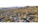 Sweeping aerial view of the neighborhood with meticulously kept homes nestled amidst the natural desert landscape at 8219 E Tesoro Cir, Mesa, AZ 85207