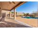 Large covered patio with a view of the pool and landscaped backyard at 8219 E Tesoro Cir, Mesa, AZ 85207