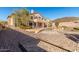 Exterior view of house showcasing an expansive backyard with pool and desert landscaping at 8219 E Tesoro Cir, Mesa, AZ 85207