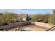 Lush backyard with mature trees, desert landscaping, and a glimpse of a swimming pool, offering privacy and tranquility at 8219 E Tesoro Cir, Mesa, AZ 85207