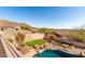 Scenic backyard with a sparkling pool, putting green, desert landscaping, and privacy walls, perfect for outdoor living at 8219 E Tesoro Cir, Mesa, AZ 85207