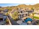 Aerial view of a backyard oasis featuring a freeform pool, outdoor seating, and lush landscaping at 8219 E Tesoro Cir, Mesa, AZ 85207