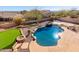 Lush backyard featuring a sparkling pool, putting green, mature landscaping, and a serene outdoor living space at 8219 E Tesoro Cir, Mesa, AZ 85207