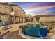 Backyard with a beautiful pool, rock features, ample patio space, and desert landscaping, ideal for relaxation at 8219 E Tesoro Cir, Mesa, AZ 85207