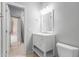 Bright bathroom showcasing a white vanity with a matching mirror, and a toilet at 8219 E Tesoro Cir, Mesa, AZ 85207