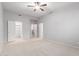 Spacious bedroom features neutral carpet, ceiling fan and closet at 8219 E Tesoro Cir, Mesa, AZ 85207
