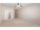 Spacious bedroom features neutral carpet, ceiling fan and closet at 8219 E Tesoro Cir, Mesa, AZ 85207