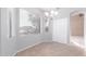 Bright dining area featuring tile floors, modern chandelier, and sliding door closet at 8219 E Tesoro Cir, Mesa, AZ 85207