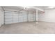 Spacious three car garage featuring neutral paint and concrete flooring at 8219 E Tesoro Cir, Mesa, AZ 85207