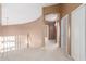 Upstairs hallway with archway, neutral colors, and carpet flooring at 8219 E Tesoro Cir, Mesa, AZ 85207