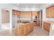 Spacious kitchen with stainless appliances, tile floors, and an island cooktop at 8219 E Tesoro Cir, Mesa, AZ 85207