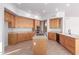 Open kitchen featuring tan cabinets, granite countertops, and a center island with a cooktop at 8219 E Tesoro Cir, Mesa, AZ 85207