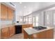 Open concept kitchen featuring tan cabinets, granite countertops, and gas cooktop island at 8219 E Tesoro Cir, Mesa, AZ 85207