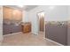 Functional laundry room features wooden cabinets, a sink, and tile flooring at 8219 E Tesoro Cir, Mesa, AZ 85207