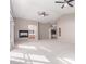 Spacious living room with plush carpeting, modern ceiling fans, and fireplace, offering a cozy and inviting atmosphere at 8219 E Tesoro Cir, Mesa, AZ 85207