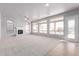 Bright living room with large windows, fireplace, and tile flooring at 8219 E Tesoro Cir, Mesa, AZ 85207