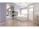 Elegant bathroom featuring a soaking tub, a fireplace, a walk-in shower, and views of the outdoors at 8219 E Tesoro Cir, Mesa, AZ 85207