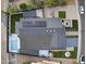 An overhead view of a home featuring solar panels, a pool, modern landscaping, and a patio area at 8409 E Clarendon Ave, Scottsdale, AZ 85251