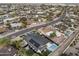An aerial view showcases the home's solar panels, private pool, and beautifully landscaped surroundings at 8409 E Clarendon Ave, Scottsdale, AZ 85251