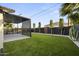 Beautiful backyard featuring a well-manicured lawn and a stylish pergola-covered patio area at 8409 E Clarendon Ave, Scottsdale, AZ 85251