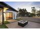Outdoor fire pit near bedroom provides a perfect backyard ambiance for relaxation and entertaining at 8409 E Clarendon Ave, Scottsdale, AZ 85251