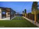 Backyard view features an artificial lawn, pergola, and sleek outdoor living at 8409 E Clarendon Ave, Scottsdale, AZ 85251
