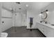 Modern bathroom featuring walk-in shower, dual sinks, and sleek design at 8409 E Clarendon Ave, Scottsdale, AZ 85251