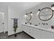 Bright bathroom with double sink vanity, stylish mirrors, and contemporary fixtures at 8409 E Clarendon Ave, Scottsdale, AZ 85251