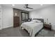 Bedroom featuring decorative brick wall, window with chair, and comfortable sleeping space at 8409 E Clarendon Ave, Scottsdale, AZ 85251