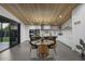 Open concept dining and kitchen area with sleek modern black and white design at 8409 E Clarendon Ave, Scottsdale, AZ 85251