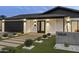 Striking modern home featuring desert landscaping, a walkway, and a well-lit facade at 8409 E Clarendon Ave, Scottsdale, AZ 85251