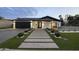 Beautiful modern home featuring a walkway and manicured landscaping leading to the front door and an attached garage at 8409 E Clarendon Ave, Scottsdale, AZ 85251