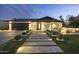 Charming modern home features a well-lit walkway, manicured landscaping, and a warm, inviting presence at 8409 E Clarendon Ave, Scottsdale, AZ 85251